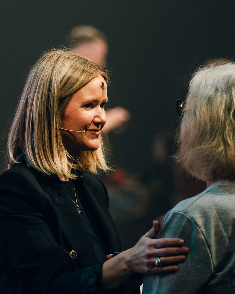 Luann Riley smiling warmly in conversation
