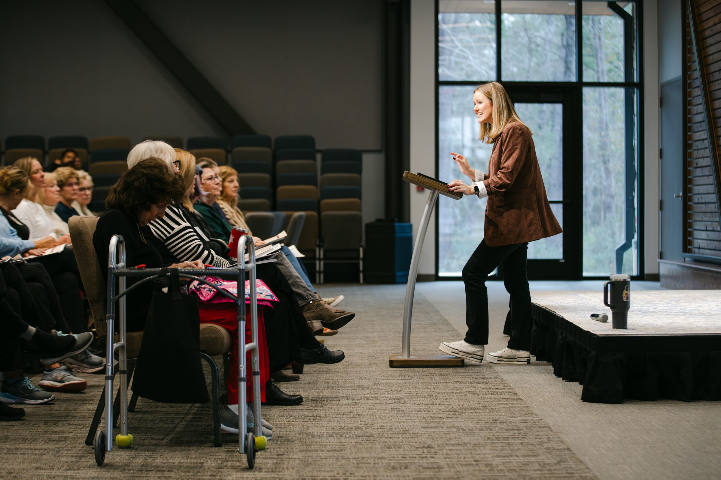 Luann Riley teaching a room full of attendees at a gathering